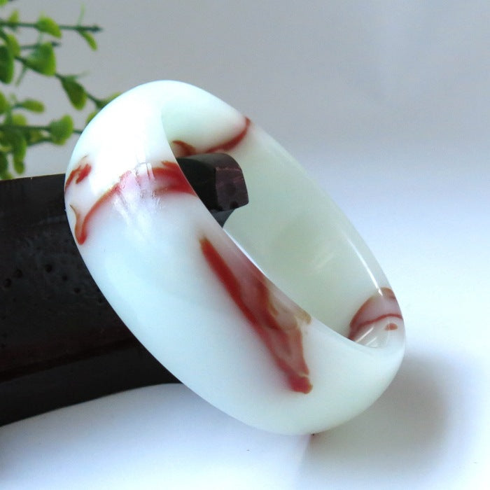 Natural jade bangle red floating pattern, glossy polished surface detail