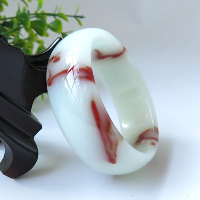 Luxury natural jade bangle, polished rounded profile and red floating pattern