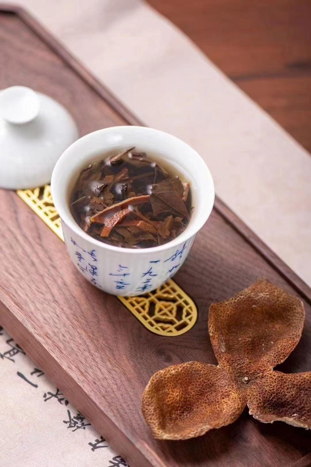 Brewed Chenpi aged white tea with warm amber liquor