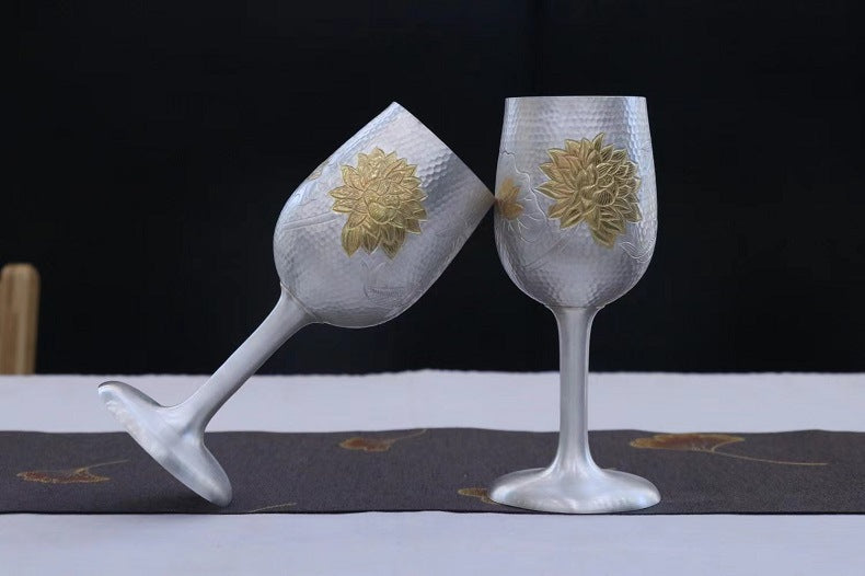 Two matching 999 fine silver wine goblets with lotus accents