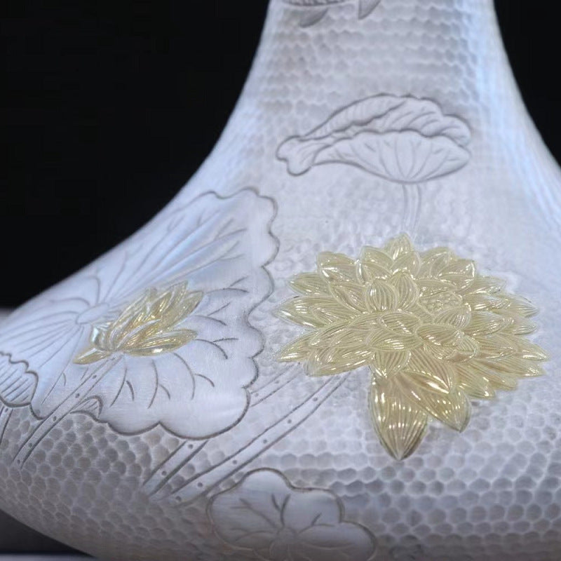 Close-up lotus and koi decoration on 999 fine silver wine decanter