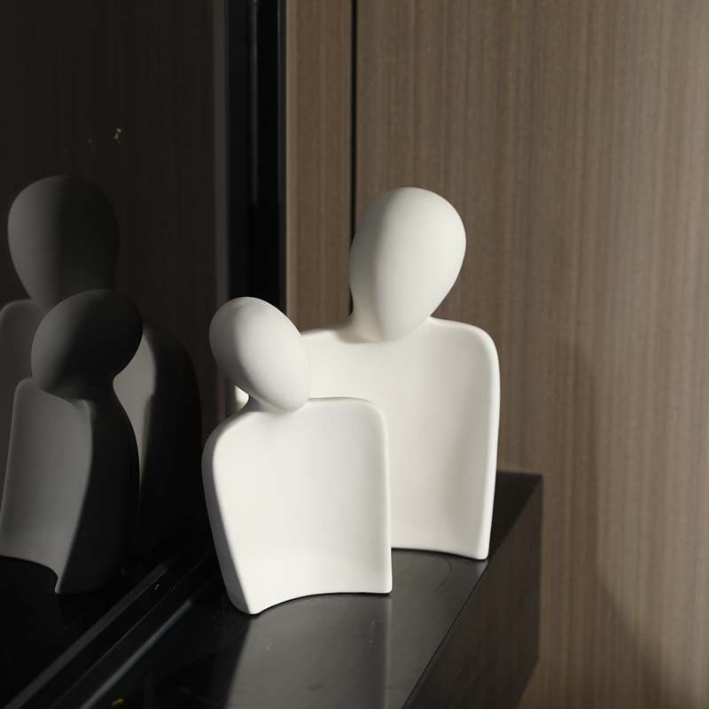 Abstract white ceramic embracing couple sculpture in minimalist New Chinese interior