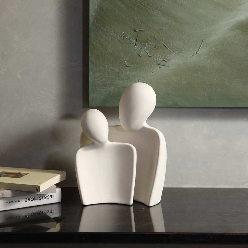 Minimalist embracing couple ceramic statue on dark console table