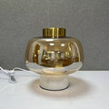 Amber glass globe table lamp with white marble base and brass top
