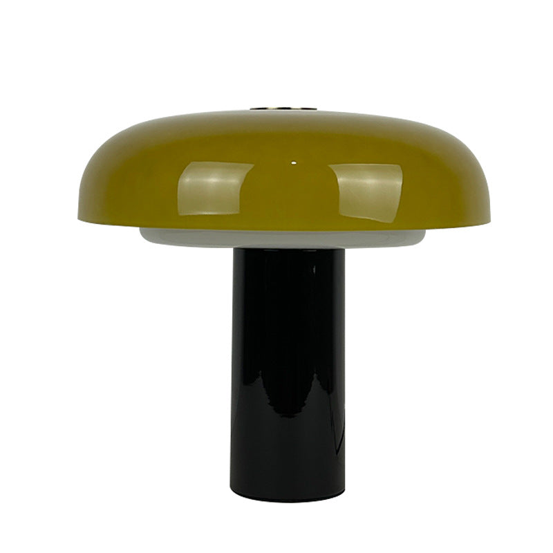 Amber glass mushroom table lamp with black cylindrical metal base front view