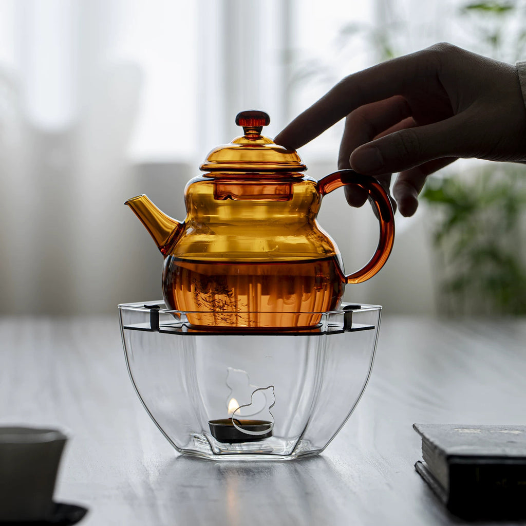 Amber glass teapot on transparent candle warmer