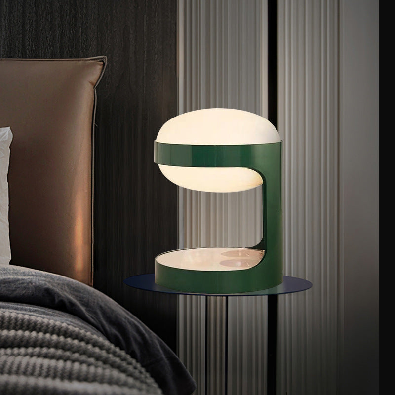 Green sculptural table lamp styled in a contemporary bedroom