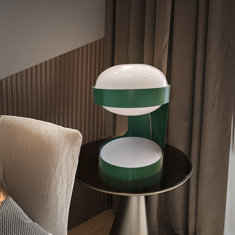 Green opal globe table lamp styled beside an armchair