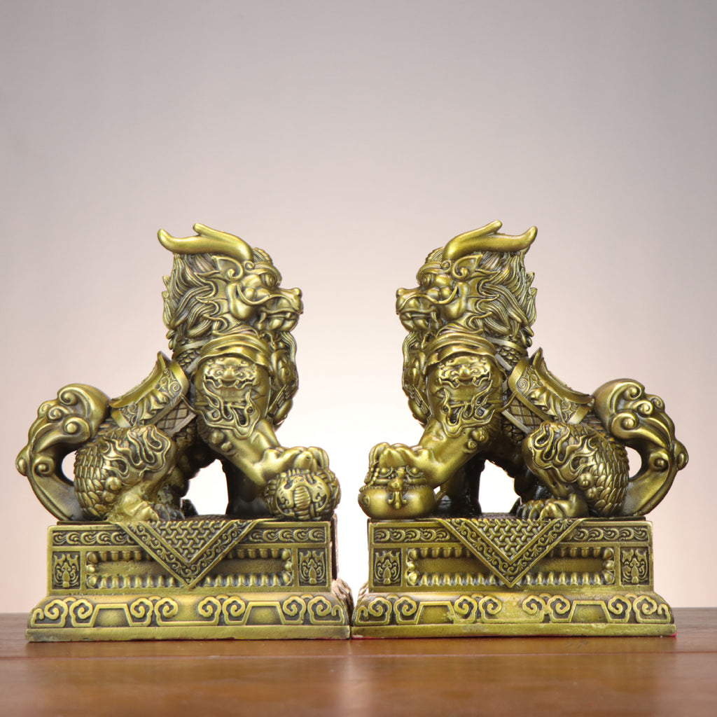 Side view of Chinese Bagua Qilin copperware pair with cloud tails, armor details, treasure bag and auspicious symbols