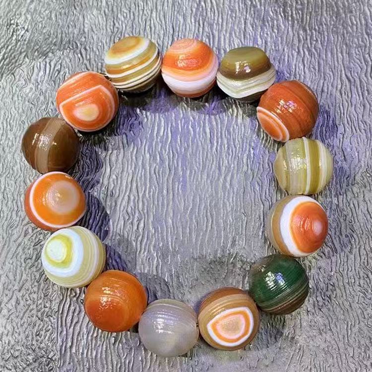 Orange brown green and cream agate bead bracelet close view