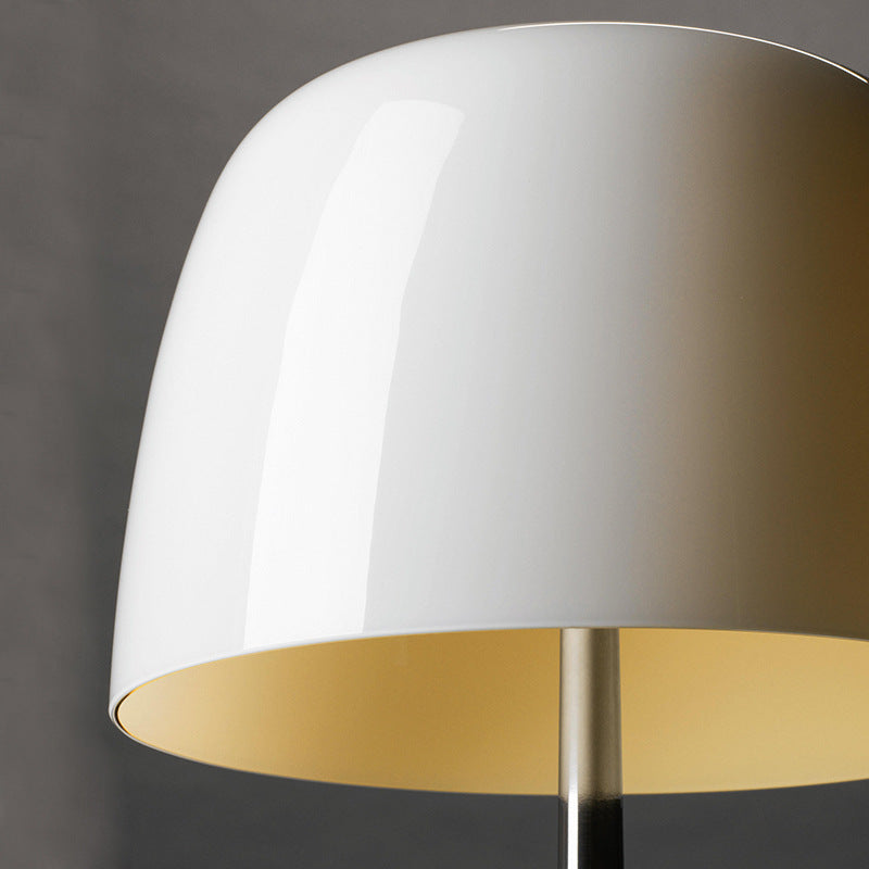 Close-up glossy white blown glass dome shade on modernist tripod table lamp