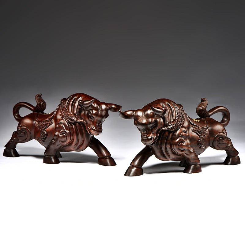 Pair of black ebony wood carved Wall Street Bull sculptures with dark polished finish