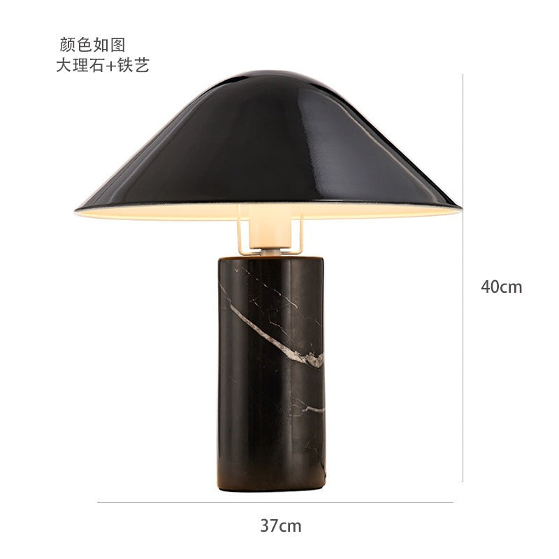 Black marble mushroom bedside lamp glowing warmly