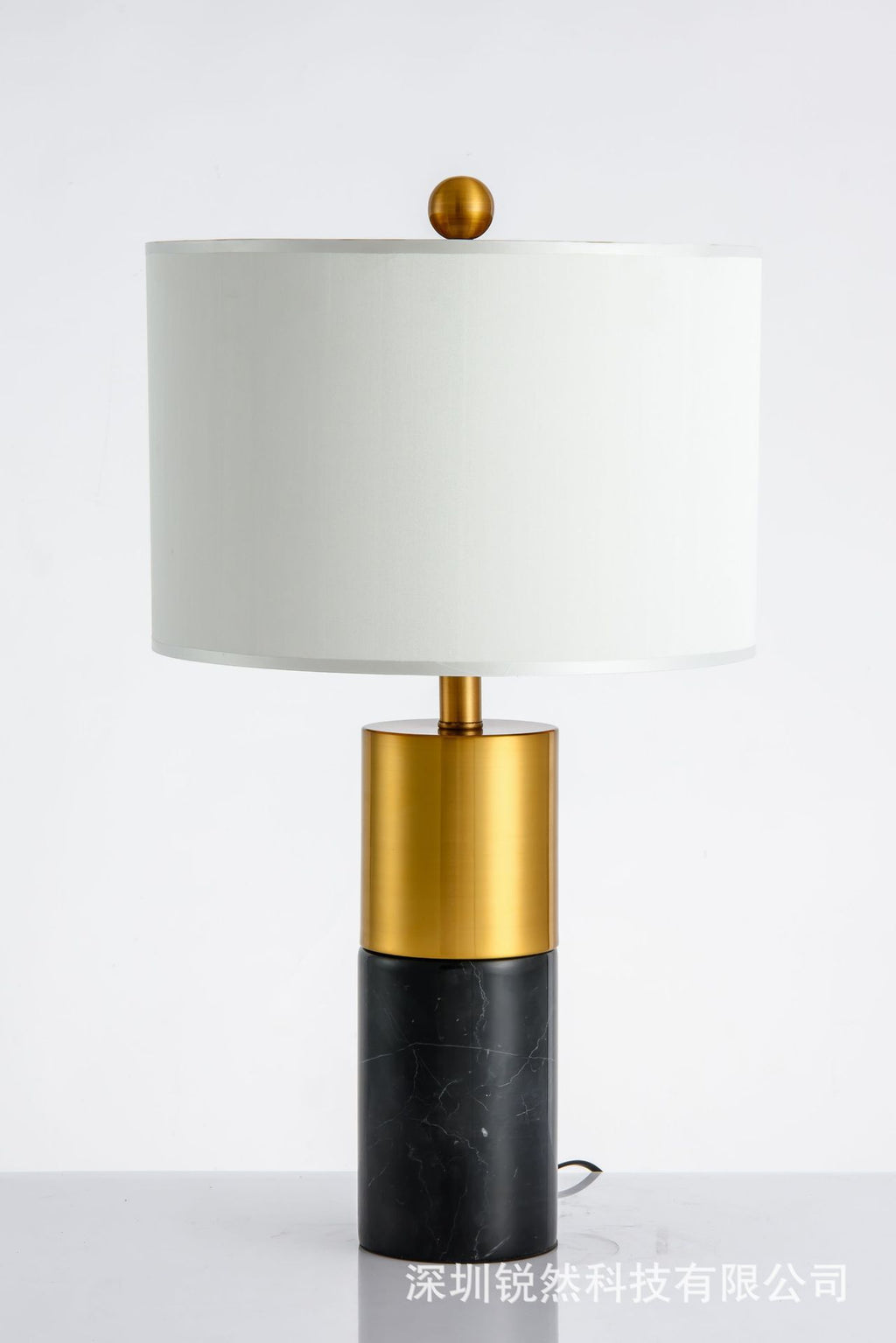 Black marble column table lamp with brushed brass body and white shade