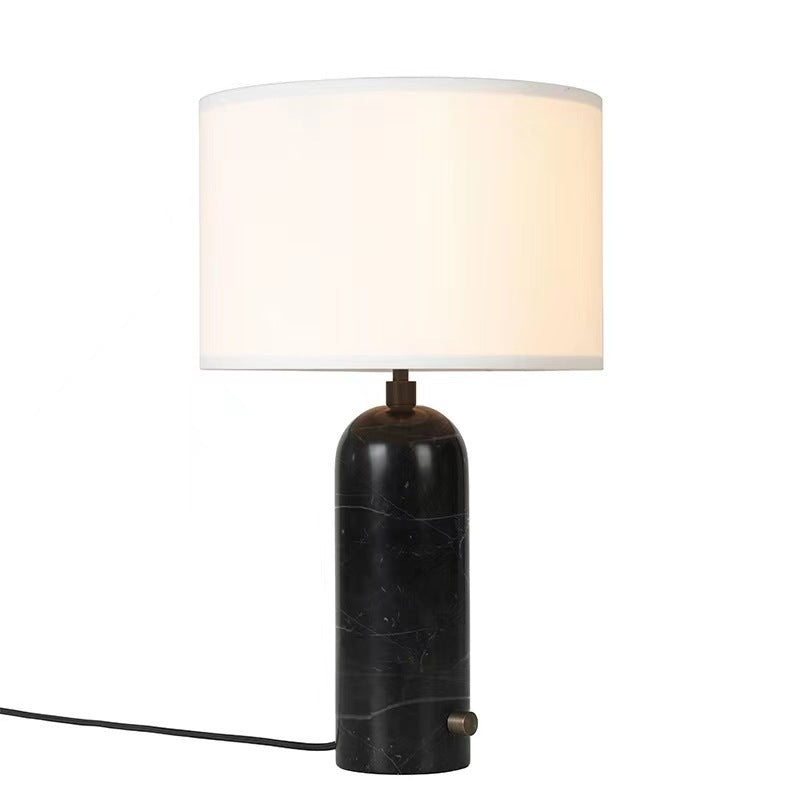Black marble capsule table lamp with white fabric drum shade