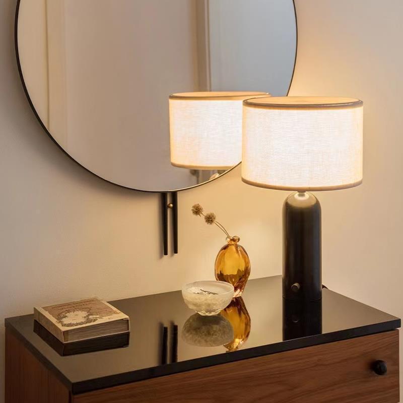 Black marble Gravity table lamp styled beside mirror on console