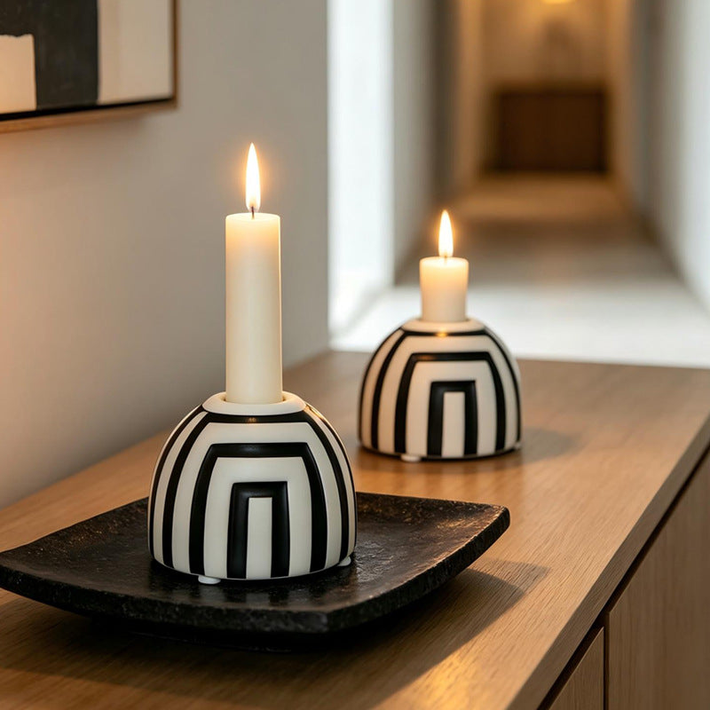 Black and white ceramic candle holders styled on wood console