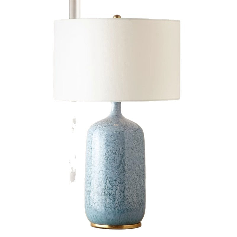 Tall ice-blue crackle glaze ceramic table lamp with white linen drum shade