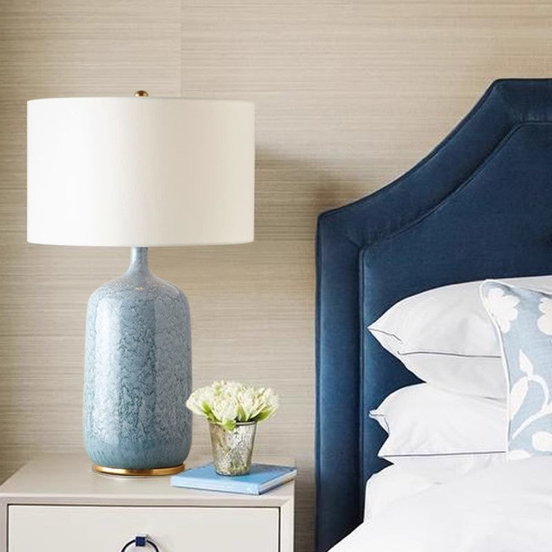 Blue crackle ceramic bedside lamp styled in a modern bedroom