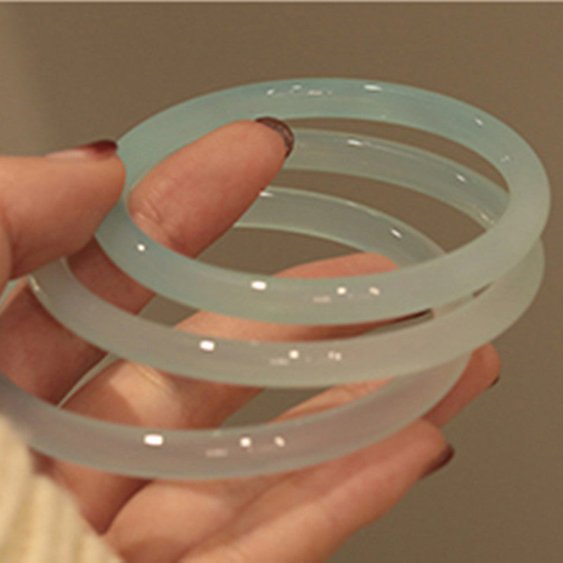 Icy translucent pale blue chalcedony round thin bangle close up