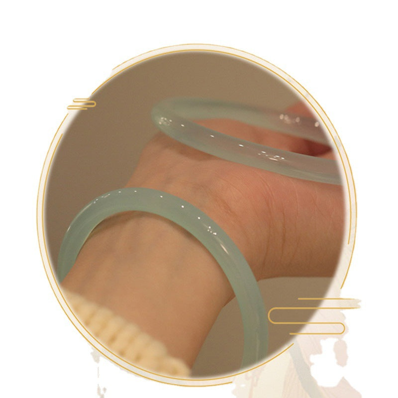 Slim blue chalcedony bangle worn on hand for scale