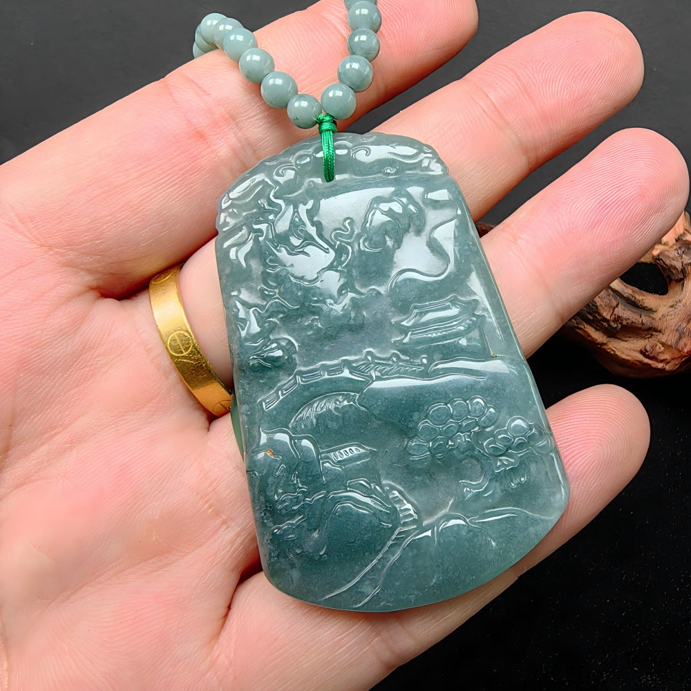 Jadeite landscape dragon pendant hand scale showing substantial plaque size