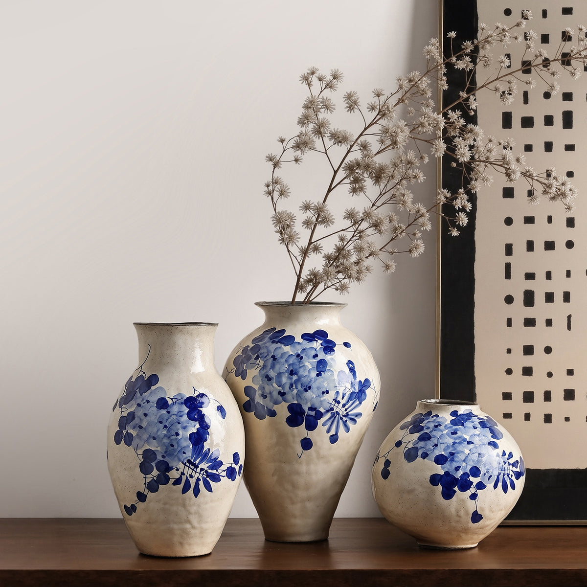 Blue and white wisteria ceramic vase styled with dried branches in a New Chinese interior
