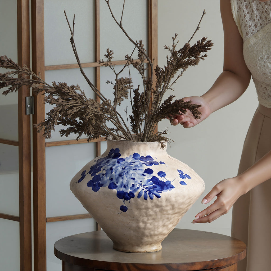 Rounded blue floral ceramic vase with hand-painted wisteria-style brushwork