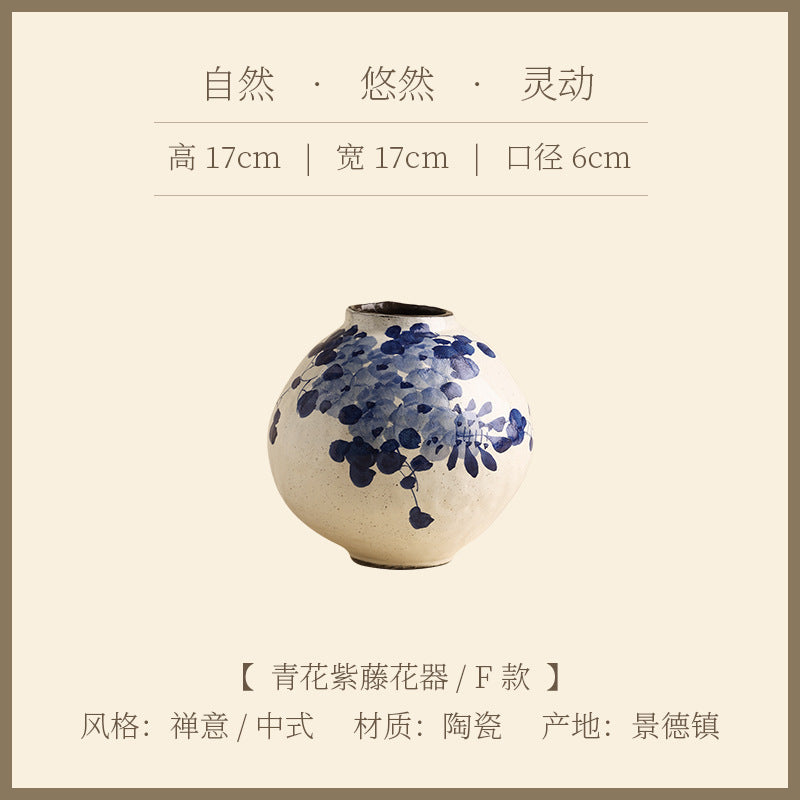 Tall blue and white ceramic vase with indigo botanical decoration