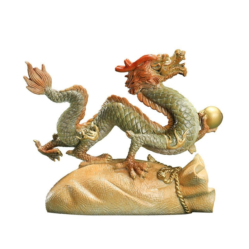 Chinese brass dragon wealth and prosperity sculpture on fortune bag isolated on white background
