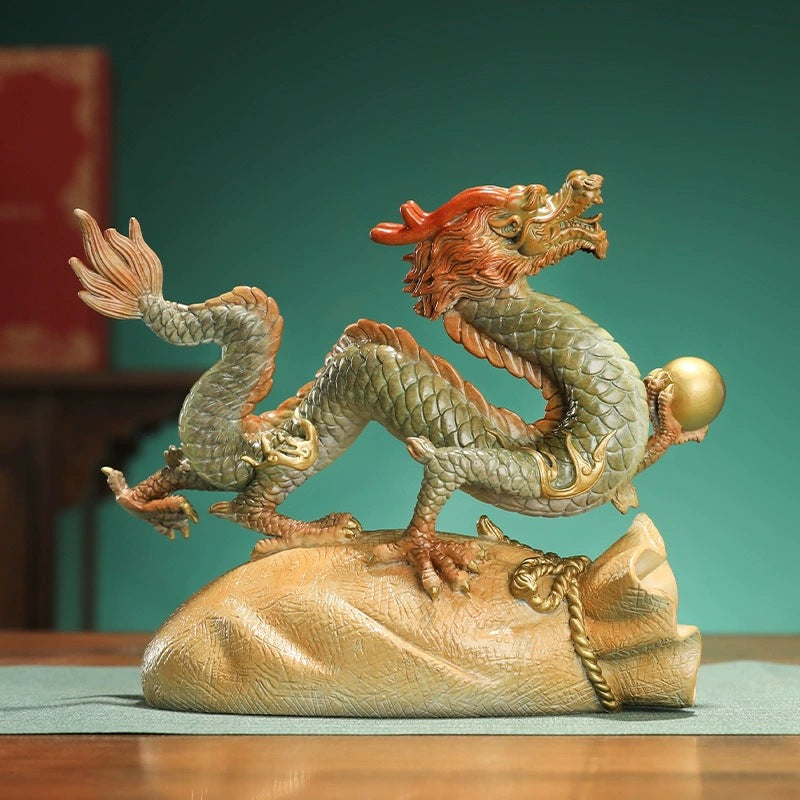 Brass Chinese dragon prosperity ornament side view with pearl and fortune bag base