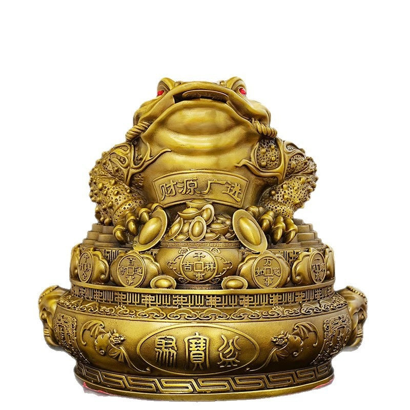 Golden brass Jin Chan money toad treasure bowl with Chinese coins and prosperity motifs on white background