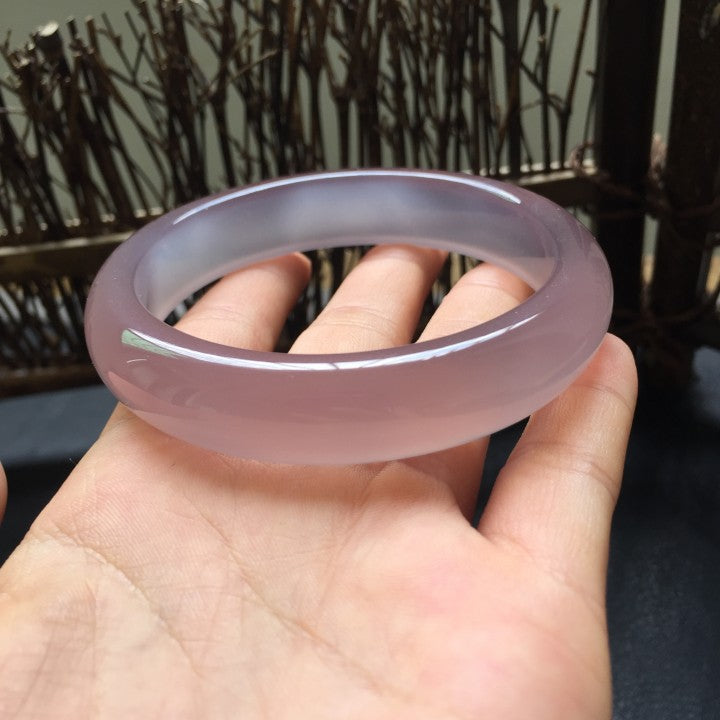 Polished lavender chalcedony solid stone bangle in natural light