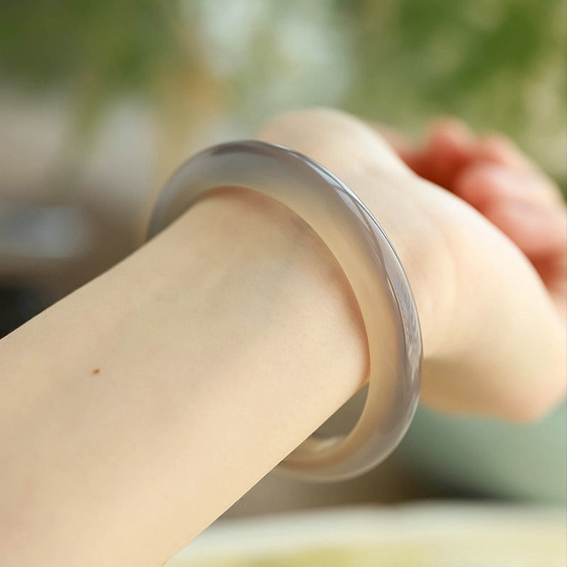 Certified natural Brazilian smoky gray agate bangle styled on wrist