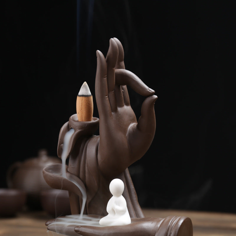 Close-up Buddha hand backflow incense cone and waterfall channel