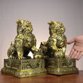 Chinese Caifu General Qilin copperware pair with Bagua chest medallions, treasure bag and ingot details on ornate bases