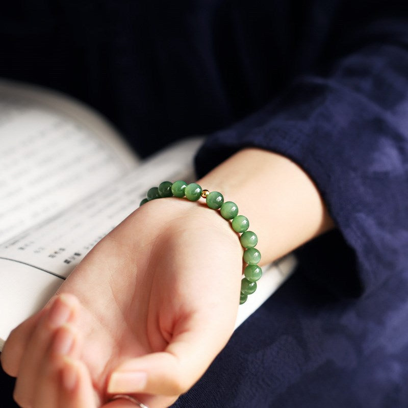 Certified green nephrite cat-eye bracelet with gold accent spacer
