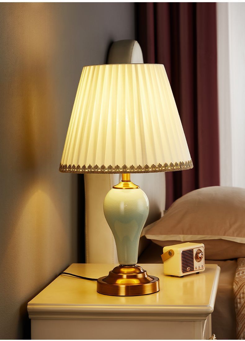 Celadon green ceramic bedside lamp with pleated fabric shade