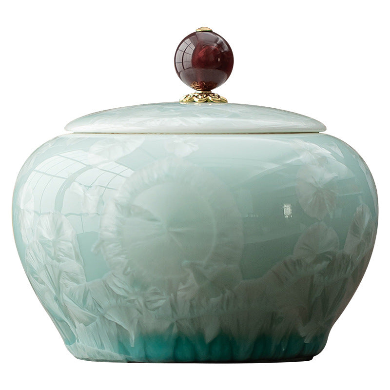 Round celadon crystalline glaze ceramic tea canister with decorative red lid finial