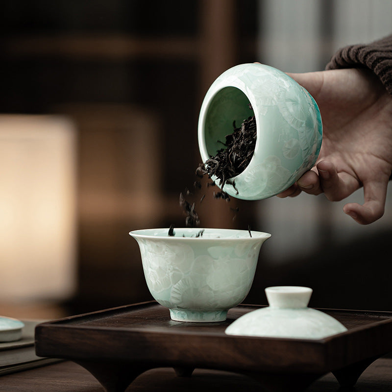 Loose-leaf tea poured from celadon crystalline glaze ceramic storage jar