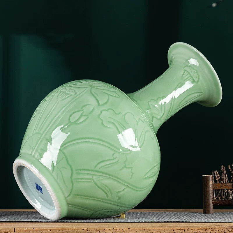Celadon lotus vase showing glossy glaze and carved floral body