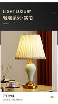 Celadon green ceramic table lamp with pleated cream shade and brass-tone base