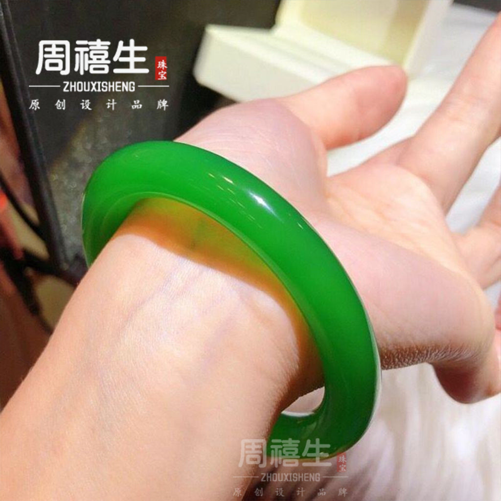 Polished green chalcedony bangle worn on wrist for scale