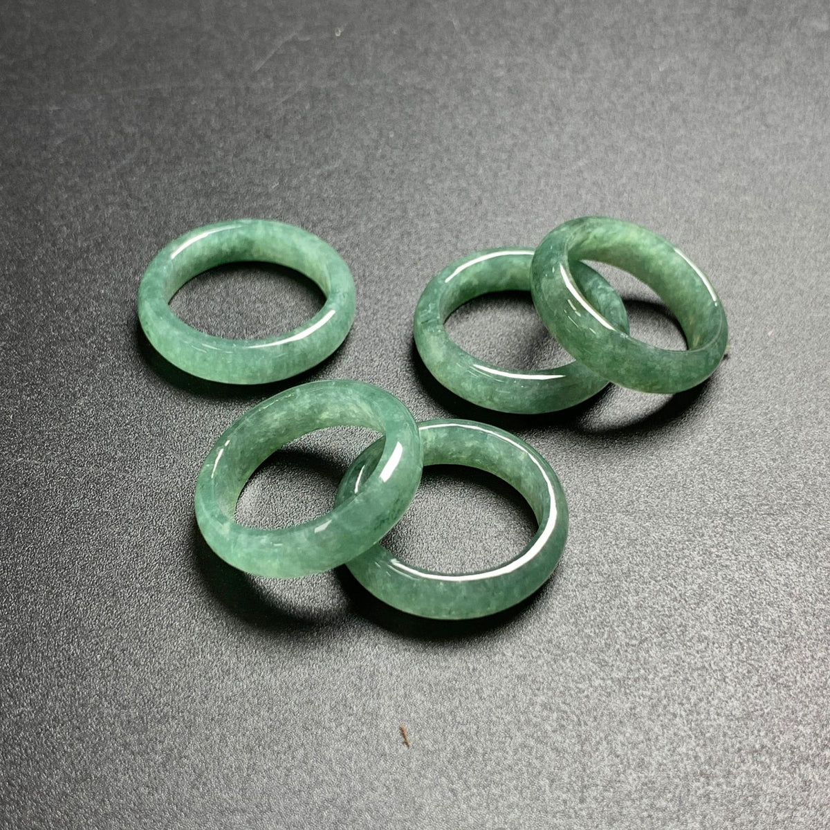 Certified natural green jadeite band rings with polished floating green stone texture