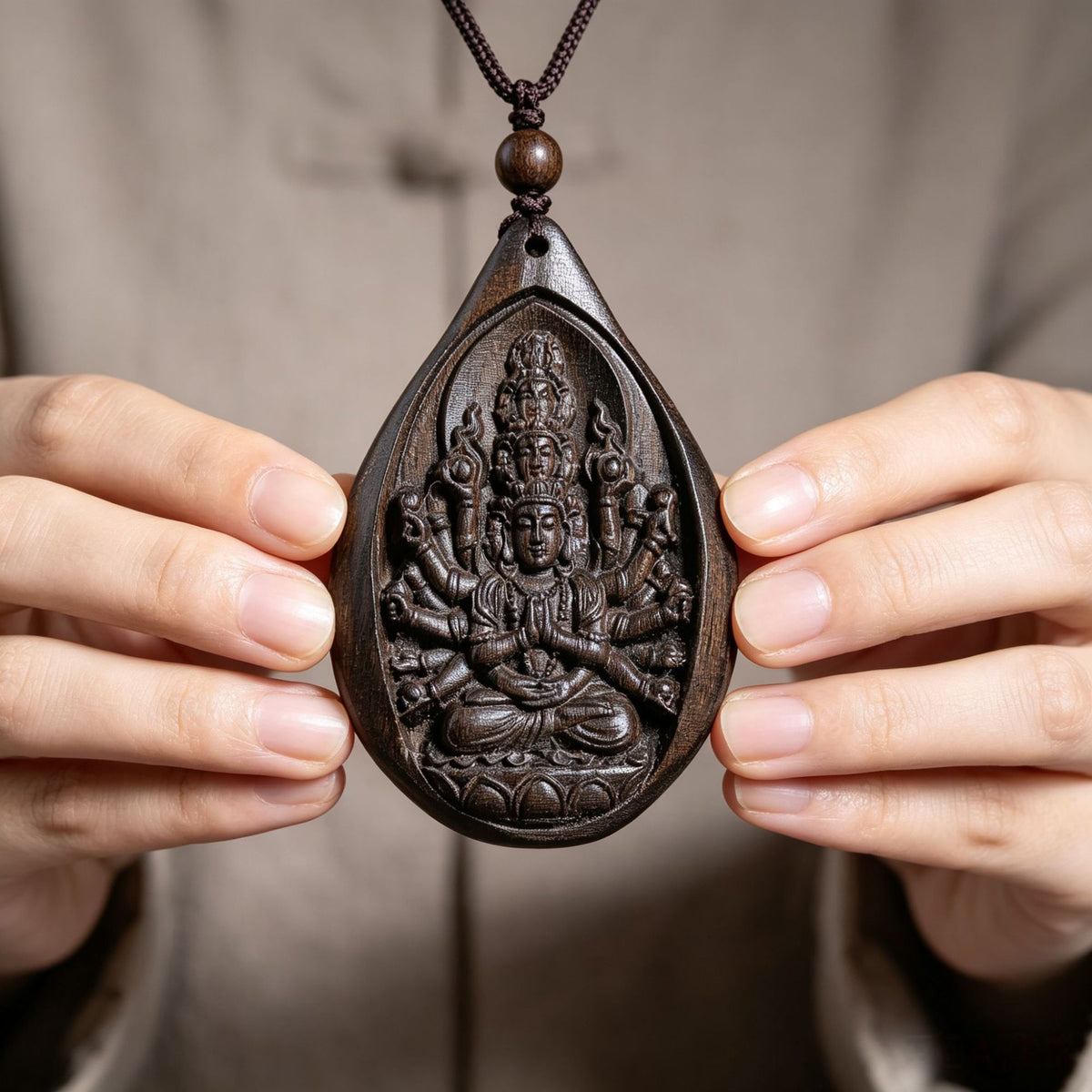 Chenxiang wood teardrop pendant carved with Thousand-Hand Guanyin motif