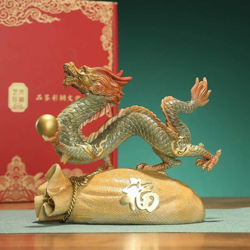 Chinese brass dragon displayed on a fortune bag with Fu character for Feng Shui inspired interior decor