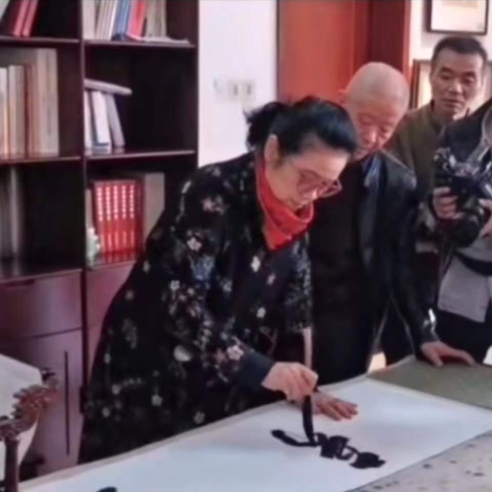 Chinese calligrapher demonstrating traditional brush calligraphy technique