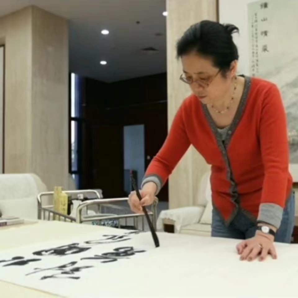 Traditional Chinese brush calligraphy demonstration on large white paper
