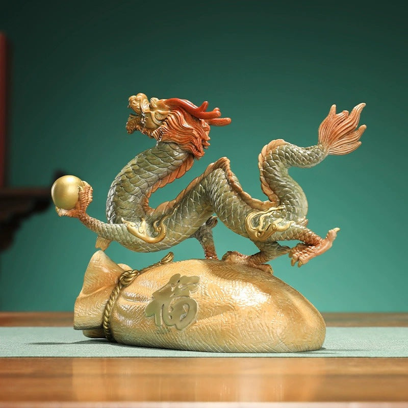 Brass Chinese dragon holding a pearl above a Fu fortune bag for office desk reception and shelf decor