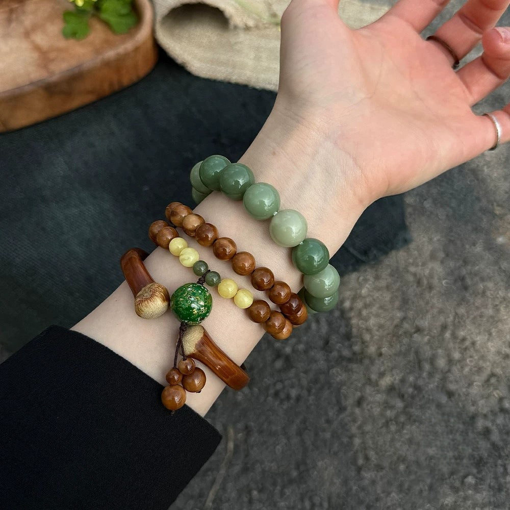 Chunhe Jingming Kuk Bodhi layered wrist styling with polished brown beads, yellow-green accents and green focal ornament